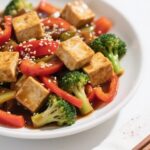 veggie stir fry with tofu served with bell peppers and broccolini