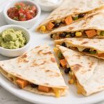 Crispy veggie quesadilla with cheese and sautéed vegetables