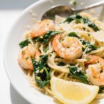Lemon Garlic Shrimp Pasta With Spinach served hot in a white bowl