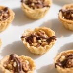 Mini Baklava Cups on wooden tray with honey drizzle