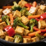 tofu stir-fry with colorful vegetables in skillet