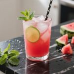 Watermelon Mint Cooler on black marble with mint garnish and condensation