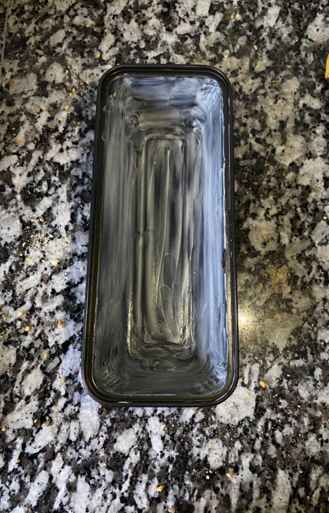 Loaf pan prepared for baking banana bread