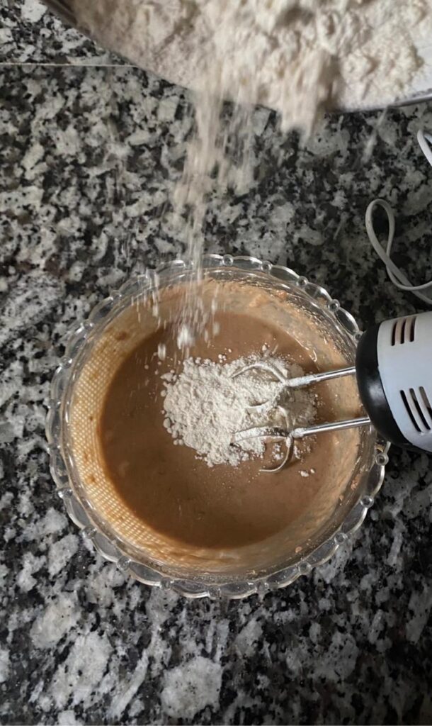 Dry ingredients being folded into the wet banana bread batter