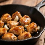 Close-up of honey garlic chicken bites glazed in sticky garlic sauce
