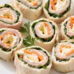 Freshly sliced turkey and cheese roll on a plate