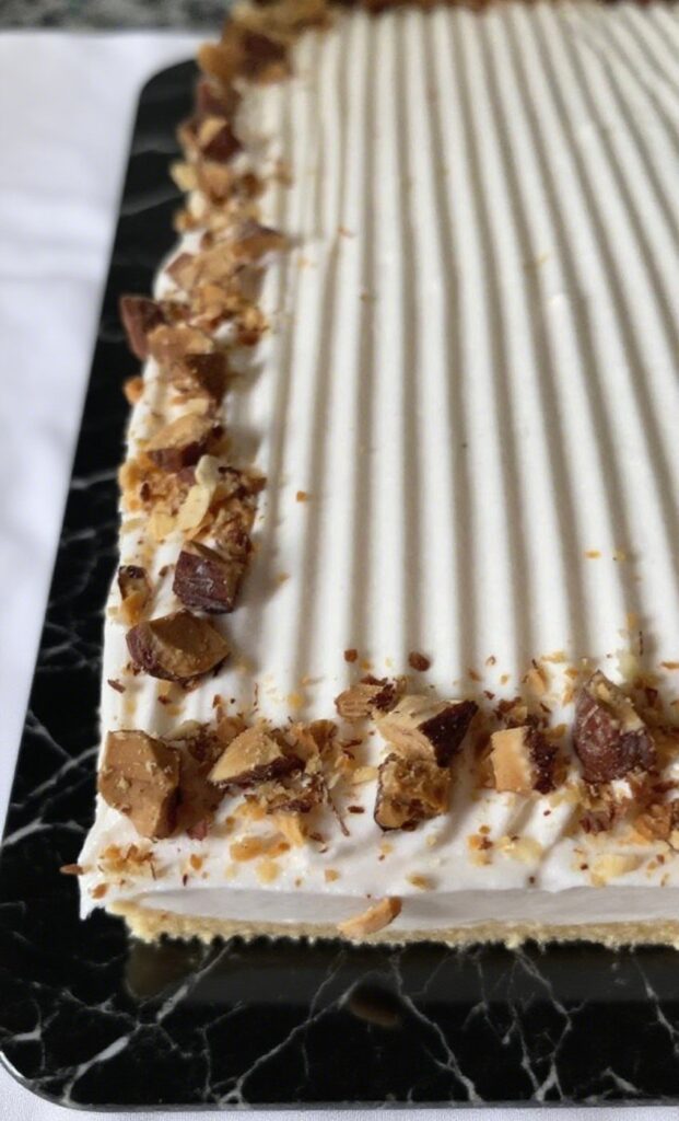 Almond Caramel Layer Cake with caramel drizzle and toasted almonds