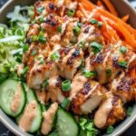 Bang Bang Chicken Bowl with crispy chicken, fresh vegetables, and creamy sauce