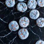 Freshly baked blackberry cookies with melted chocolate chips on tray