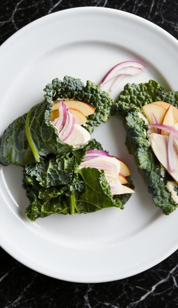 Chicken and Apple Kale Wraps on a plate, made with fresh kale leaves