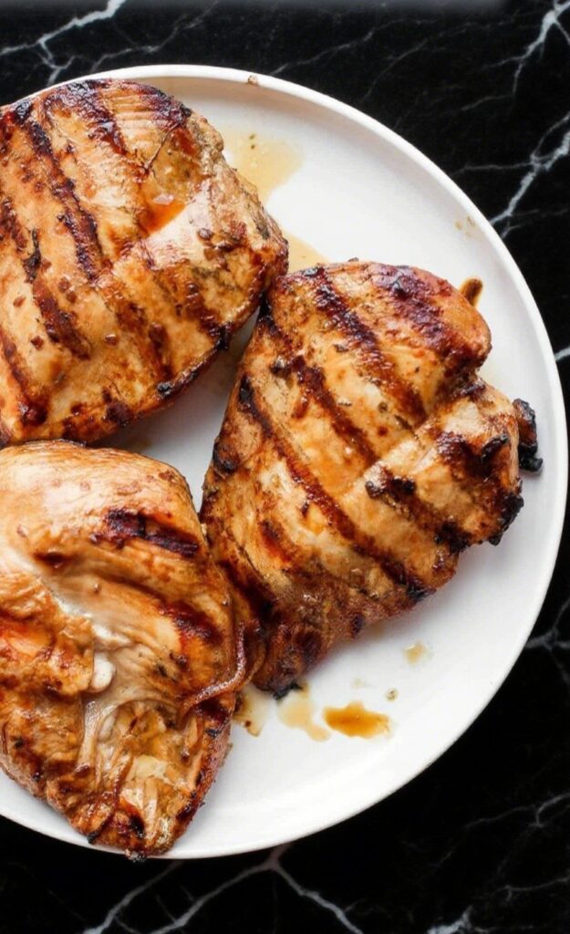 Grilled chicken breasts sliced and served on a plate
