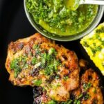 Grilled Chimichurri Chicken Thighs with fresh herbs and vegetables
