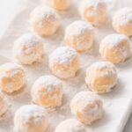 Orange Creamsicle Truffles stacked on a white marble plate