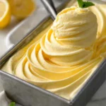 Lemon Curd Ice Cream in a Bowl with Fresh Lemons